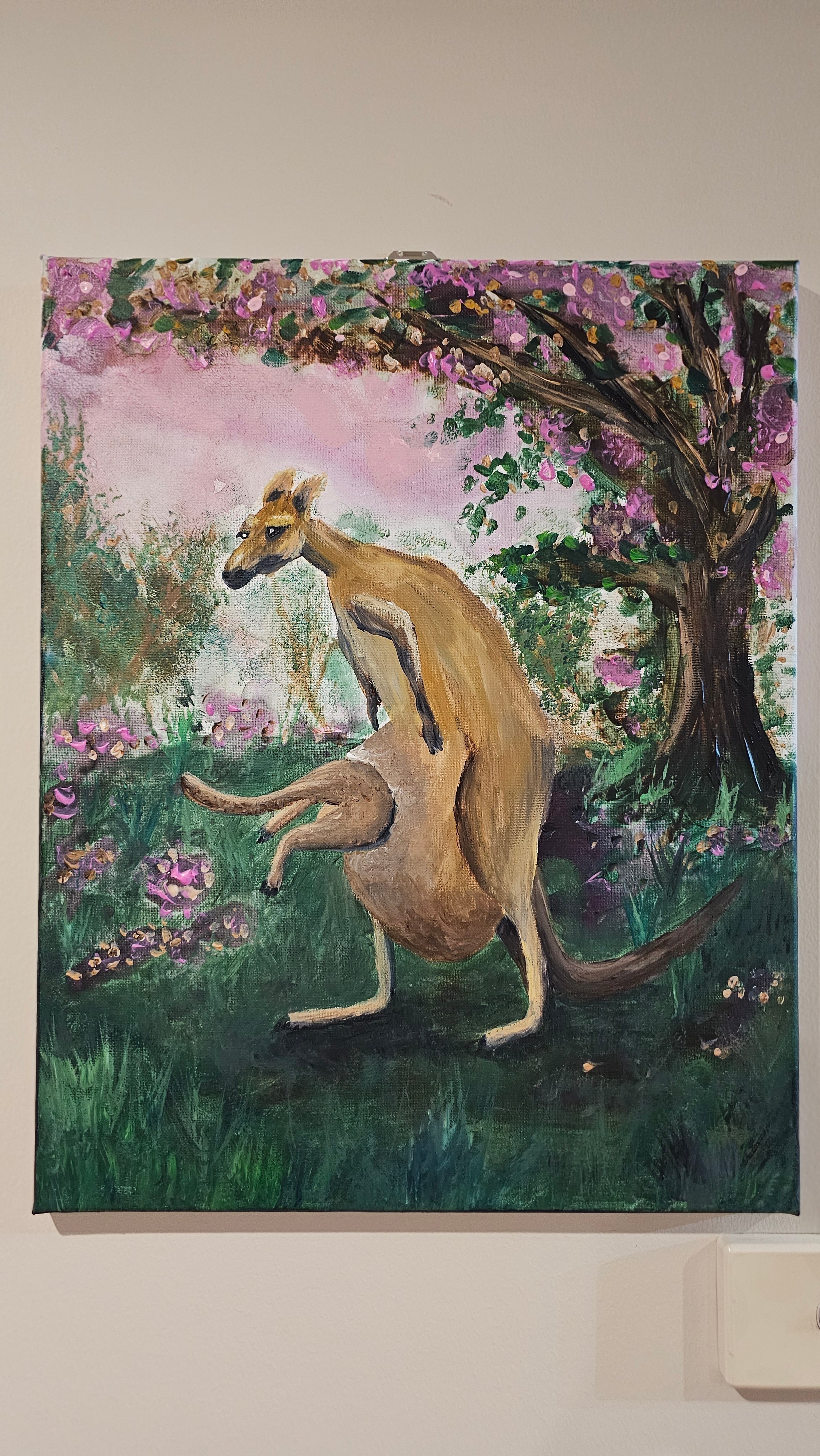Original Painting by Shelley Bailey of a kangaroo in a garden with flowers and trees. Joey bounds into mother's pouch.